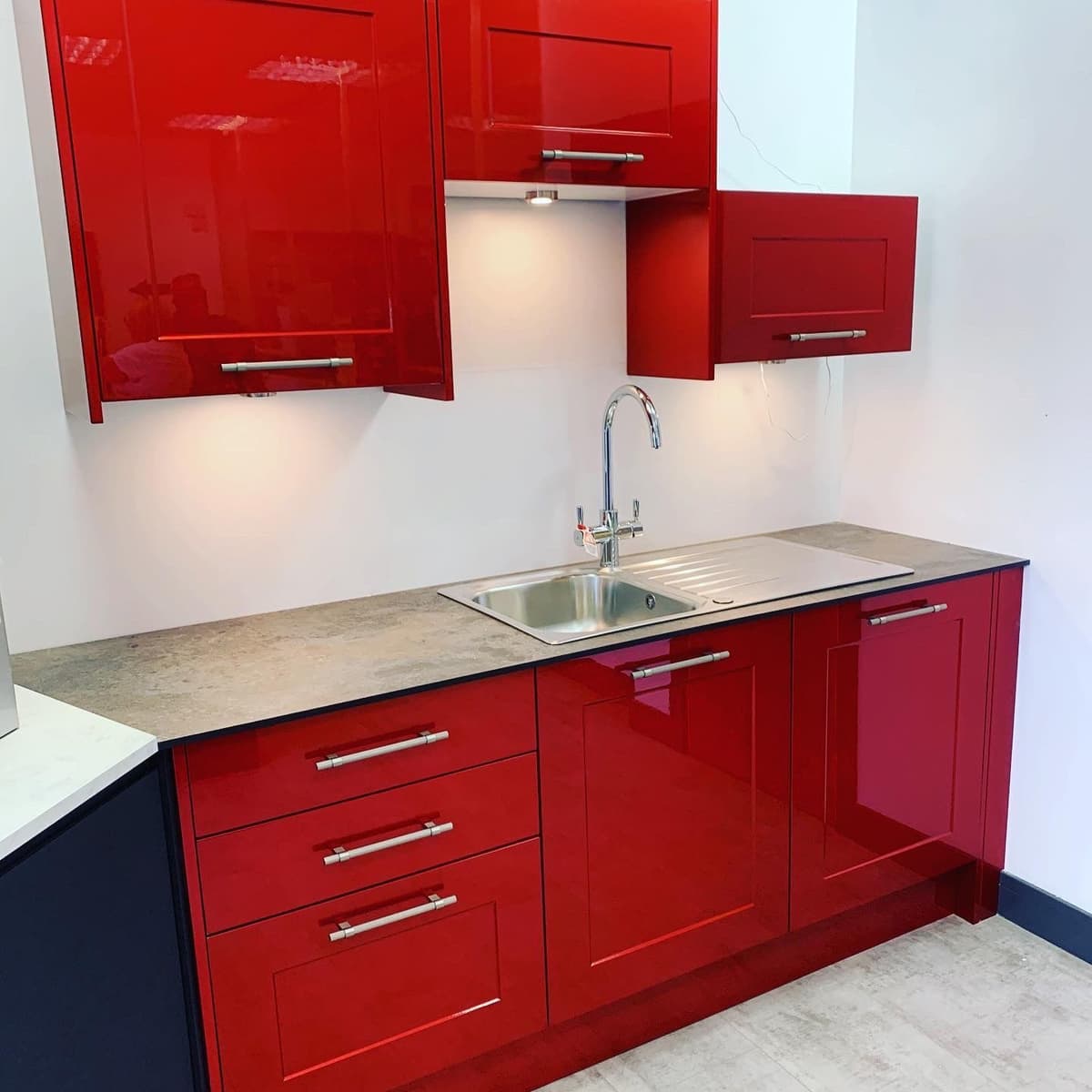 Wider view of the hand-sprayed red kitchen, doors and drawer fronts fitted