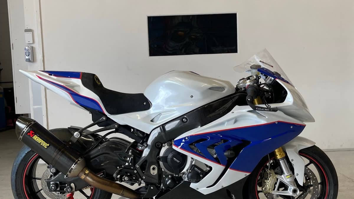 BMW S1000RR side-on, showing the full length of the white, blue and red paintwork